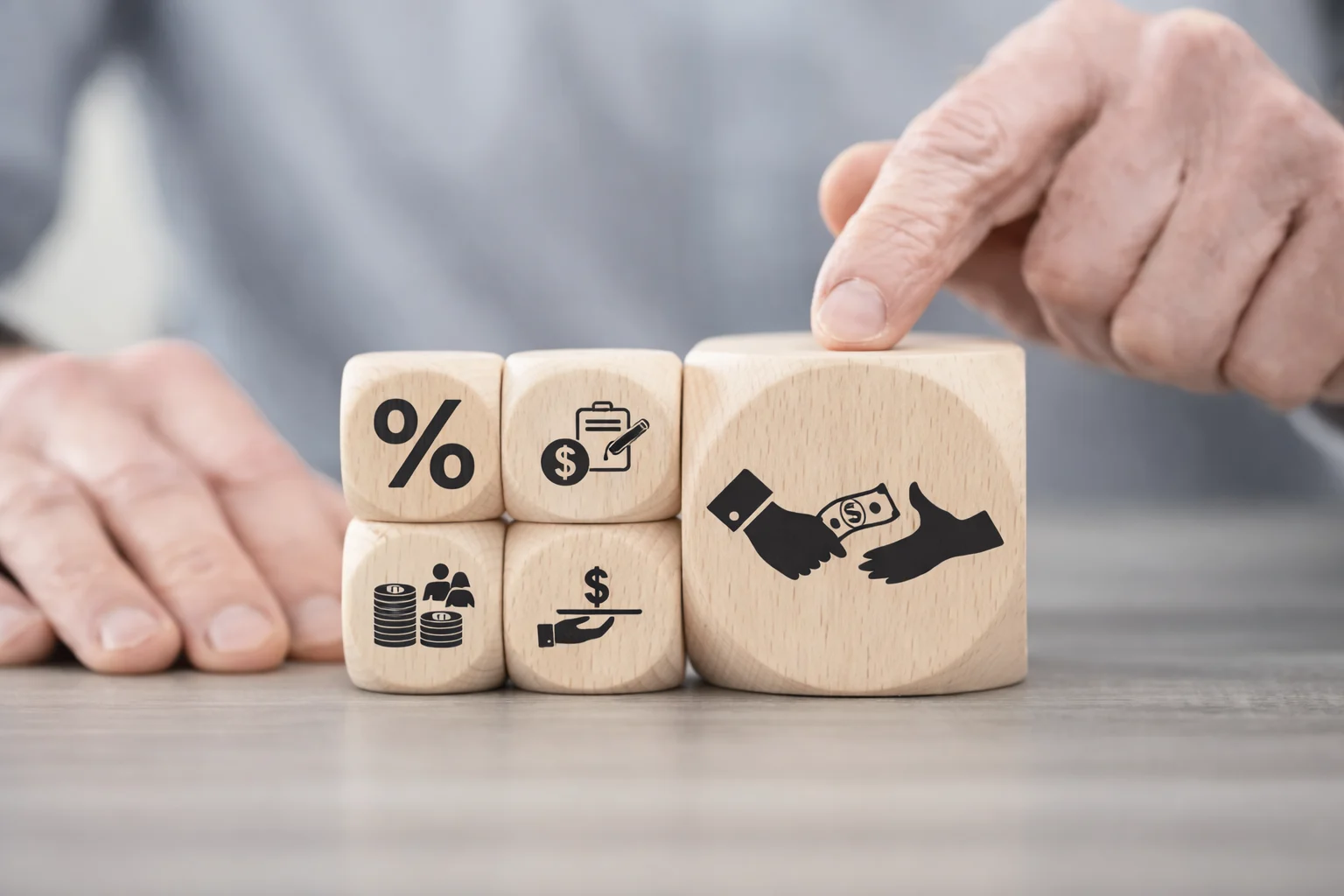 Wooden blocks with financial symbols representing personal loan vs credit card borrowing