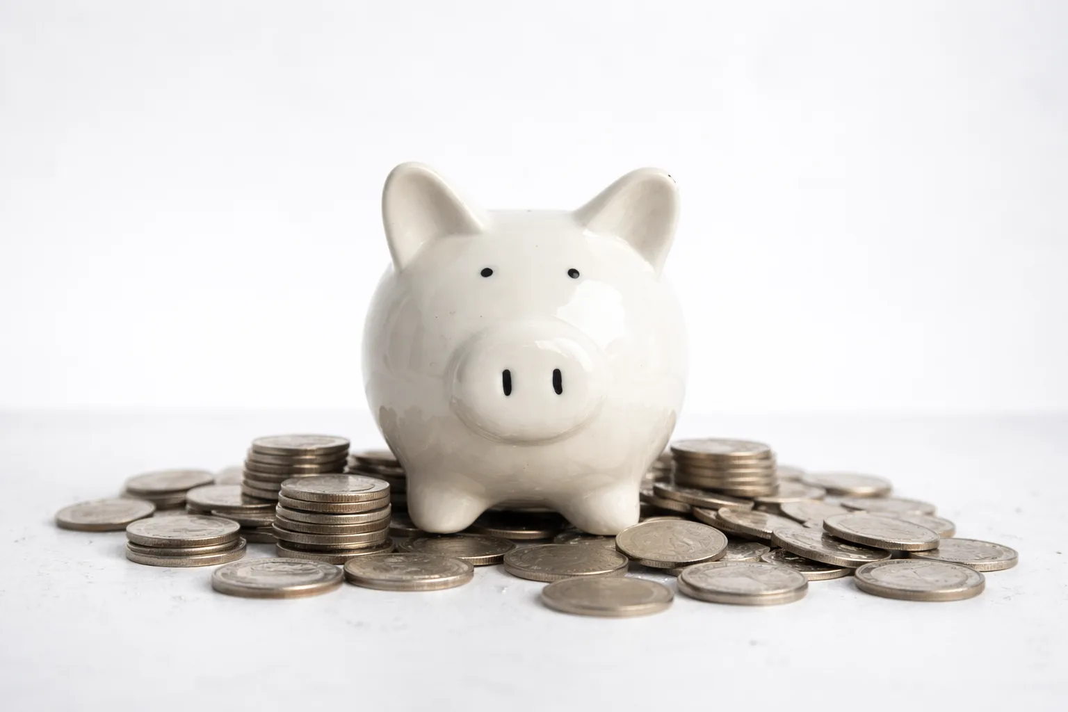 Piggy bank surrounded by coins representing high yield savings account vs traditional savings