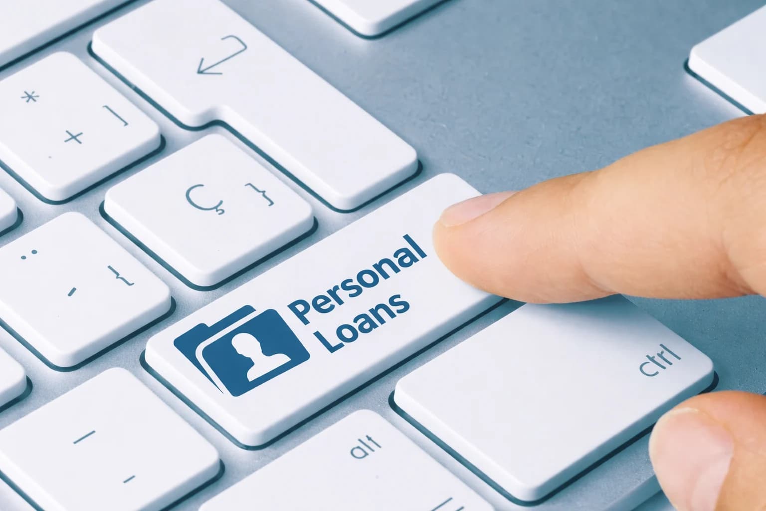 Finger pressing personal loan button on keyboard representing applying for a personal loan online