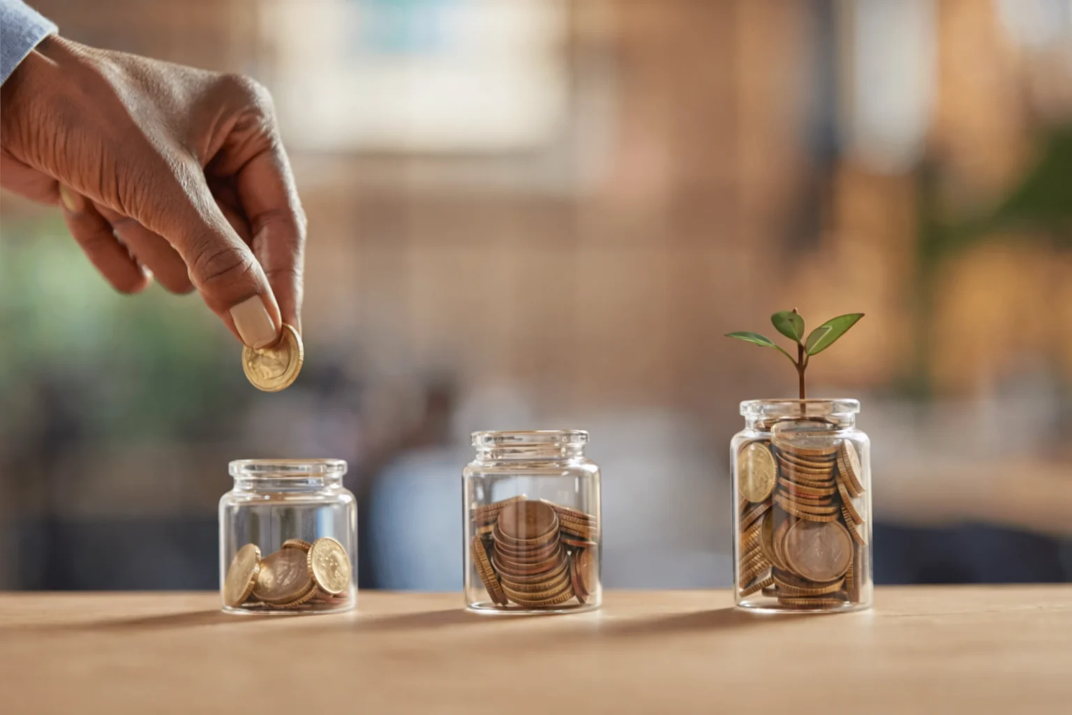 Coins growing in glass jars with small plants representing long term retirement planning and savings growth